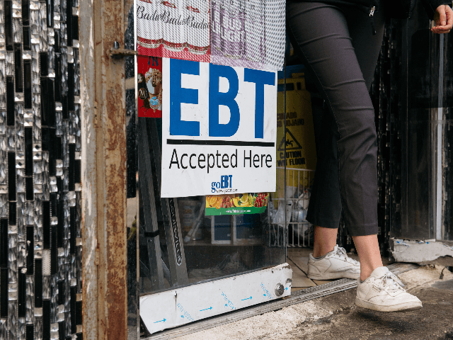 A sign alerting customers about SNAP food stamps benefits is displayed at a Brooklyn groce
