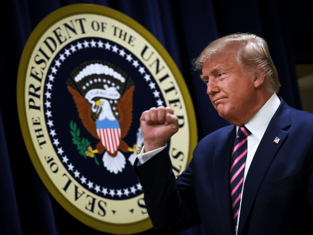 U.S. President Donald Trump pumps his fist after speaking at a White House Mental Health S