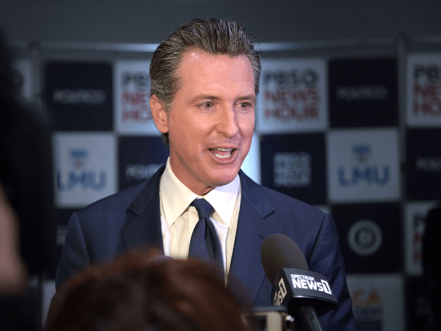 California Governor Gavin Newsom speaks to the press in the spin room after the sixth Demo