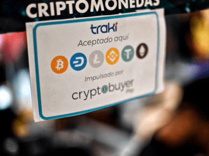 View of a sign advertising the payment with Venezuelan cryptocurrency Petro at a store in Caracas, on December 28, 2019. - The government of Venezuelan President Nicolas Maduro granted an end-of-year bonus to retirees and public employees equivalent to half a Petro (some 30 US dollars), five times more than …