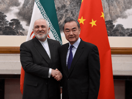 China's Foreign Minister Wang Yi (R) shakes hands with Iran's Foreign Minister Mohammad Javad Zarif during their meeting at the Diaoyutai State Guest House in Beijing on December 31, 2019. (Photo by Noel CELIS / POOL / AFP) (Photo by NOEL CELIS/POOL/AFP via Getty Images)