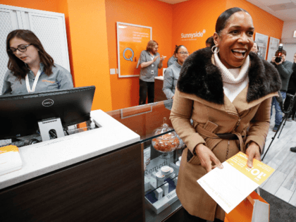 Lieutenant Governor of Illinois Juliana Stratton smiles after making a purchase at Sunnyside Cannabis Dispensary on January 1, 2020 in Chicago, Illinois. - On the first day of 2020, recreational marijuana became legal in Illinois, which joins 10 other US states with legal use of recreational marijuana. (Photo by KAMIL …