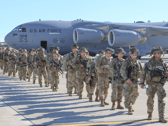 This handout picture released by the US Army shows U.S. Army Paratroopers assigned to the 2nd Battalion, 504th Parachute Infantry Regiment, 1st Brigade Combat Team, 82nd Airborne Division, deploy from Pope Army Airfield, North Carolina on January 1, 2020. - Paratroopers from 2nd Battalion, 504th Parachute Infantry Regiment, 1st Brigade …