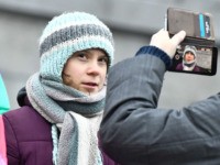 Swedish environmental activist Greta Thunberg poses for pictures as she takes part in the weekly "Fridays For Future" climate strike outside on climate emergency outside the Swedish parliament in Stockholm on January 03, 2020. (Photo by Claudio BRESCIANI / TT NEWS AGENCY / AFP) / Sweden OUT (Photo by CLAUDIO …