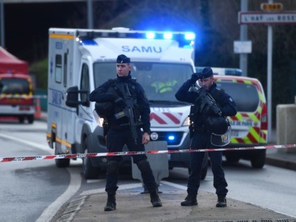 Police officers stand guard on January 3, 2020 in L'Hay-les-Roses on the site where police shot dead a knife-wielding man who killed one person and injured at least two others in a nearby park of the south of Paris' suburban city of Villejuif. - The man had attacked "several people" …