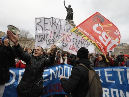 Protestors hold banners during a demonstration called by French national trade union General Confederation of Labour (CGT) against the pension reform on January 4, 2020, on the Place de la Republique in Paris. - After 30 days of strike, unions opposed to the pension reform promise not to give respite …