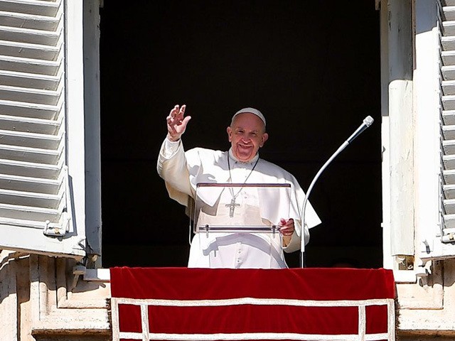 Pope Francis waves to worshipers from the window of the Apostolic palace overlooking St. P