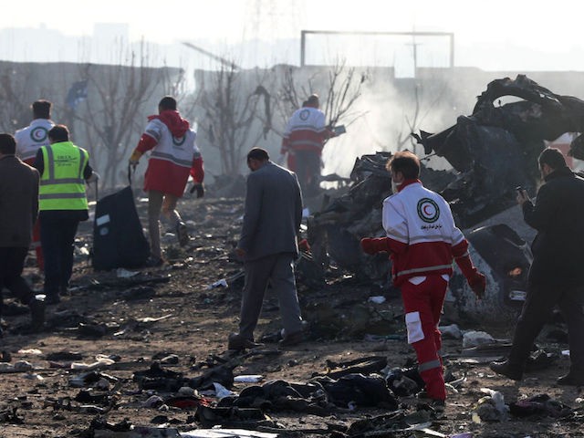 Rescue teams work amidst debris after a Ukrainian plane carrying 176 passengers crashed near Imam Khomeini airport in the Iranian capital Tehran early in the morning on January 8, 2020, killing everyone on board. - The Boeing 737 had left Tehran's international airport bound for Kiev, semi-official news agency ISNA …