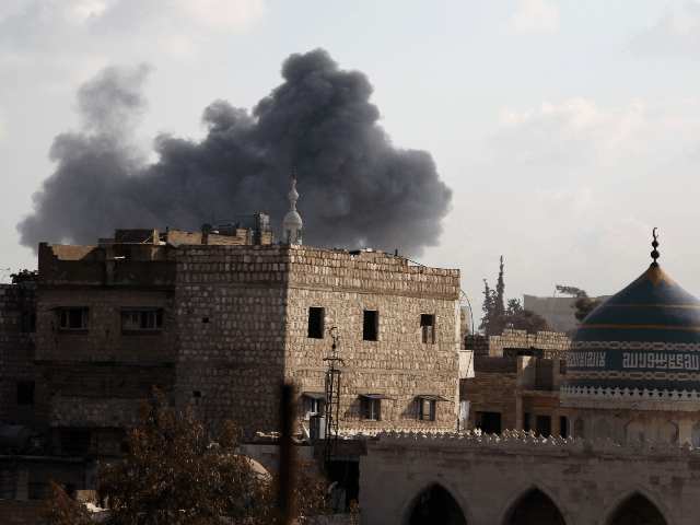 Smoke billows above buildings in the town of Maaret Al-Numan in Syria's northwestern Idlib