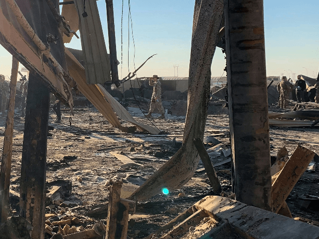 A picture taken on January 13, 2020 during a press tour organised by the US-led coalition fighting the remnants of the Islamic State group, shows US soldiers clearing rubble at Ain al-Asad military airbase in the western Iraqi province of Anbar. - Iran last week launched a wave of missiles at the sprawling Ain al-Asad airbase in western Iraq and a base in Arbil, capital of Iraq's autonomous Kurdish region, both hosting US and other foreign troops, in retaliation for the US killing top Iranian general Qasem Soleimani in a drone strike in Baghdad on January 3. (Photo by Ayman HENNA / AFP) (Photo by AYMAN HENNA/AFP via Getty Images)