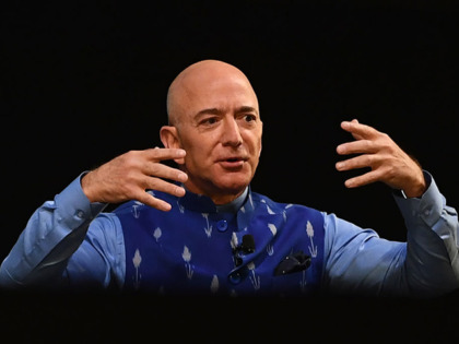 CEO of Amazon Jeff Bezos (R) gestures as he addresses the Amazon's annual Smbhav event in