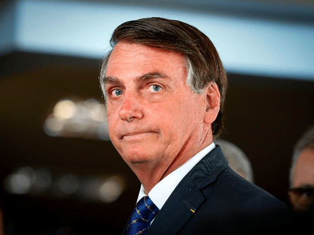 Brazilian President Jair Bolsonaro arrives for a press conference on electricity and gasoline at the Ministry of Mines and Energy in Brasilia, on January 15, 2020. - Bolsonaro spoke about Brazil's possible entry to the Organisation for Economic Co-operation and Development (OECD). (Photo by Sergio LIMA / AFP) (Photo by …