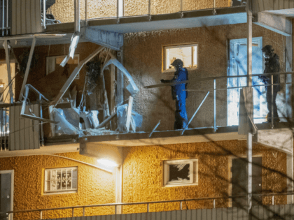 Police search a residential building that was hit by an explosion injuring one person in Husby outside of Stockholm, on January 21, 2020, where two blasts occurred within some minutes and a few hundred metres away one from each other. (Photo by Fredrik SANDBERG / TT News Agency / AFP) …