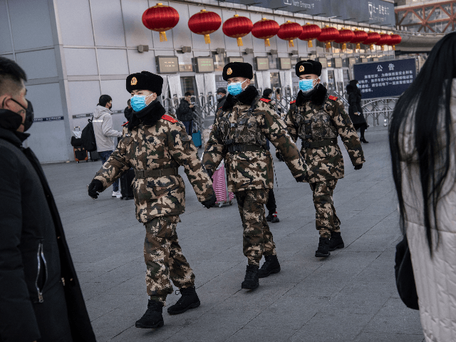 Chinese police officers wear protective masks as they patrol before the annual Spring Festival at a Beijing railway station on January 23, 2020 in Beijing, China. The number of cases of a deadly new coronavirus rose to over 500 in mainland China Wednesday as health officials locked down the city …