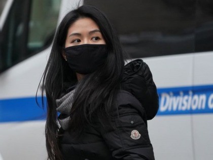 A woman wears a protective mask near the Chinatown section of New York City on January 23, 2020,as many people were seen wearing the mask in the area since the outbreak of the Wuhan Coronavirus. - Authorities in Texas are investigating a second suspected case on US soil of a …