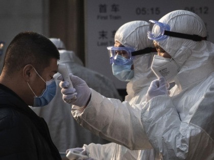 Concern In China As Mystery Virus Spreads BEIJING, CHINA - JANUARY 25: A Chinese health worker checks the temperature of a woman entering a subway station during the Chinese New Year and Spring Festival on January 25, 2020 in Beijing, China. The number of cases of a deadly new coronavirus rose to over 1300 in mainland China …