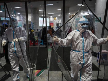 TOPSHOT - Medical staff members wearing protective clothing to help stop the spread of a d