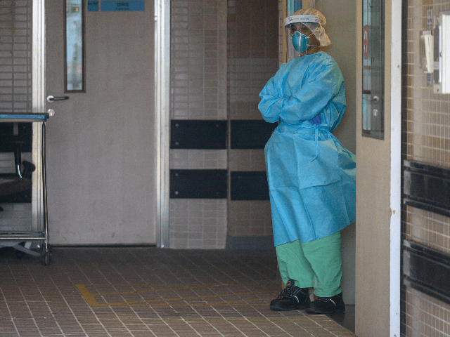 A member of the medical staff, wearing protective clothing to help stop the spread of a de