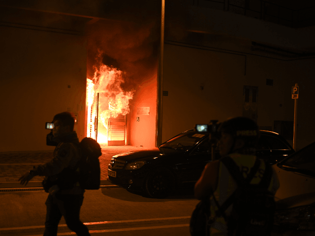 An entrance to a vacant housing block of the Fai Ming Estate is seen on fire as residents