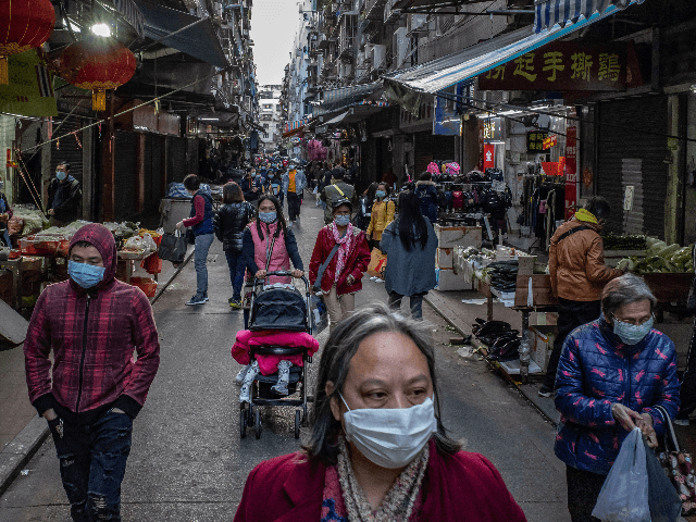 Residents wearing face masks shop at a market on January 28, 2020 in Macau, China. The num