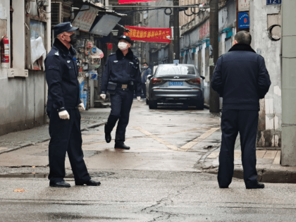 Police patrol a neighborhood on January 22, 2020 in Wuhan, China. The cause of the person'