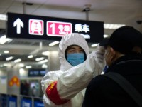 BEIJING, CHINA - JANUARY 26: A health worker checks the temperature of a man entering the subway on January 26, 2020 in Beijing, China. The number of cases of coronavirus rose to 1,975 in mainland China on Sunday. Authorities tightened restrictions on travel and tourism this weekend after putting Wuhan, …