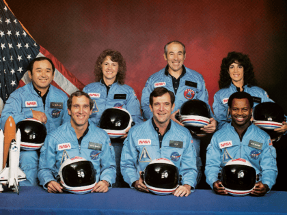 Space Shuttle Challenger crew members gather for an official portrait November 11, 1985 in an unspecified location. (Back, L-R) Mission Specialist Ellison S. Onizuka, Teacher-in-Space participant Sharon Christa McAuliffe, Payload Specialist Greg Jarvis and mission specialist Judy Resnick. (Front, L-R) Pilot Mike Smith, commander Dick Scobee and mission specialist Ron …