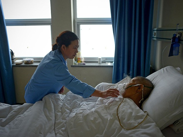 A man suffering from pneumonia receives treatment in a ward at Wang Fu Hospital in Beijing on December 9, 2015. Seeking treatment for respiratory illnesses, Beijing hospital-goers complained on December 9 that their conditions were being worsened by toxic smog, now in its third day and which prompted authorities to …
