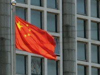 The Chinese national flag is seen on a flagpole in Beijing on August 8, 2016. - Most of the five stars on the Chinese flags being used at medal ceremonies at the Rio Olympics are misaligned, officials said, prompting a diplomatic protest and online fury. (Photo by STR / AFP) …