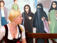 MUNICH, GERMANY - SEPTEMBER 15: A woman sits under a painting inside the Hocker-Pschorr tent that shows a woman in a burka and other Muslim women wearing headscarves in what tent woner Toni Roiderer says is a common a sight in the city center during a press preview at Theresienwiese …