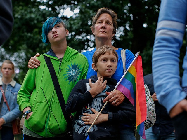 A woman and her two children attend the LGBT Pilgrimage of Mercy in Central Park New York on October 2, 2016.