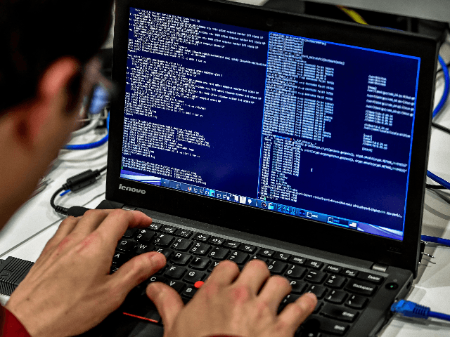 A person works at a computer during the 10th International Cybersecurity Forum in Lille on January 23, 2018. / AFP PHOTO / Philippe Huguen (Photo credit should read PHILIPPE HUGUEN/AFP via Getty Images)