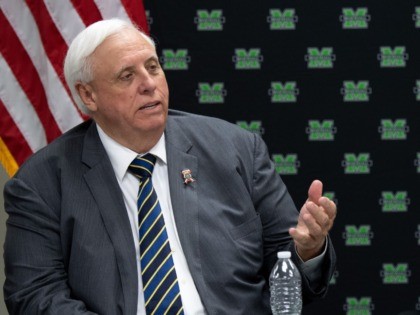 US First Lady Melania Trump and West Virginia Governor Jim Justice (L) attend a roundtable discussion on the opioid epidemic with local and state officials at the Cabell-Huntington Health Department in Huntington, West Virginia, July 8, 2019. (Photo by SAUL LOEB / AFP) (Photo credit should read SAUL LOEB/AFP via …