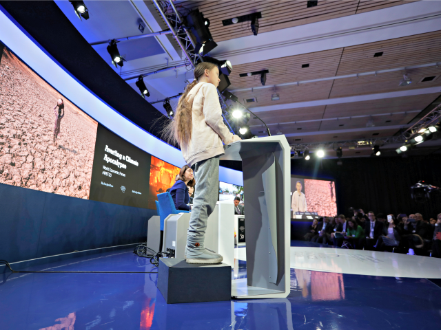 Swedish environmental activist Greta Thunberg stands on an elevation as she addresses guests at the World Economic Forum in Davos, Switzerland, Tuesday, Jan. 21, 2020. The 50th annual meeting of the forum will take place in Davos from Jan. 21 until Jan. 24, 2020. (AP Photo/Michael Probst)