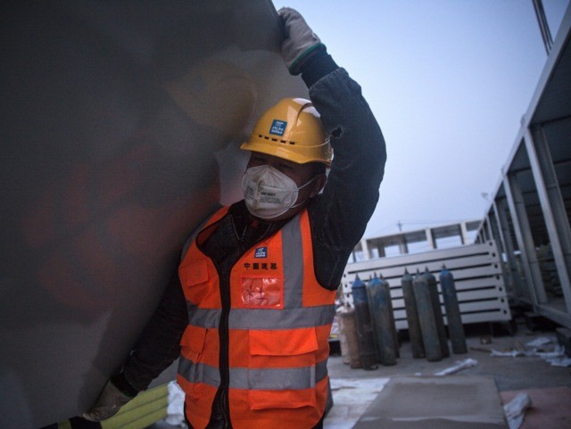 WUHAN, CHINA - JANUARY 28: (CHINA OUT) A worker carrying construction material at Huoshens
