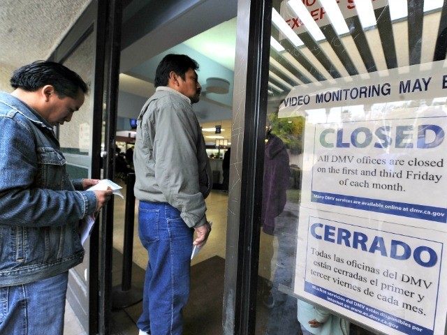 People wait in line to get into a California Department of Motor Vehicles office in Los An