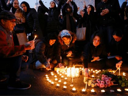 Iranians light candles for the victims of Ukraine International Airlines Boeing 737 during a gathering in front of the Amirkabir University in the capital Tehran, on January 11, 2020. - Iran said it "unintentionally" shot down a Ukrainian passenger jet, killing all 176 people aboard, in an abrupt about-turn after …