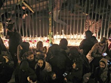 Iranians light candles for the victims of Ukraine International Airlines Boeing 737 during a gathering in front of the Amirkabir University in the capital Tehran, on January 11, 2020. - Iranian police dispersed students chanting "radical" slogans Saturday during a gathering in Tehran to honour the 176 people killed when …
