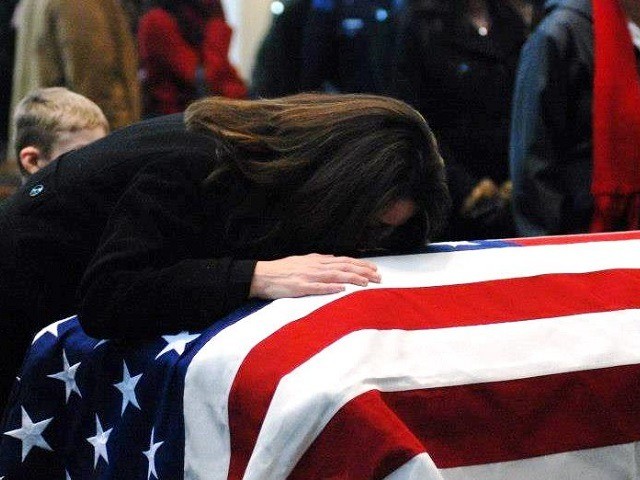 Kelly Terry-Willis holds the flag-draped casket of her brother, slain Border Patrol Agent