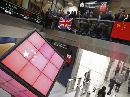 An illuminated cube bearing the Chinese flag is pictured in the entrance foyer of the London Stock Exchange, after British Chancellor of the Exchequer Philip Hammond and Bank of China chairman Tian Guoli opened the markets for the start of trading, in central London on November 10, 2016, as part …