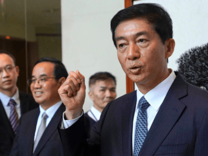 Newly appointed head of China's liaison office in Hong Kong, Luo Huining gestures as he sp