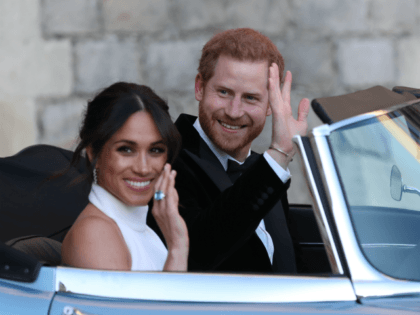 WINDSOR, UNITED KINGDOM - MAY 19: Duchess of Sussex and Prince Harry, Duke of Sussex wave as they leave Windsor Castle after their wedding to attend an evening reception at Frogmore House, hosted by the Prince of Wales on May 19, 2018 in Windsor, England. (Photo by Steve Parsons - …