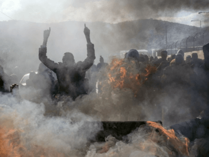 Refugees and migrants burn garbage bins and chant slogans as they demonstate outside Moria camp, following the stabbing death of an 20-year-old man from Yemen in the Greek island of Lesbos, Friday, Jan, 17, 2020. Authorities arrested a 27-year-old Afghan migrant in connection with the incident. Overcrowding at Moria has …