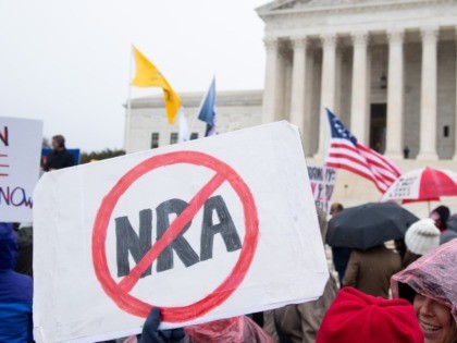 Supporters of gun control and firearm safety measures hold a protest rally outside the US Supreme Court as the Court hears oral arguments in State Rifle and Pistol v. City of New York, NY, in Washington, DC, December 2, 2019. - The case marks the first time in nearly 10 …