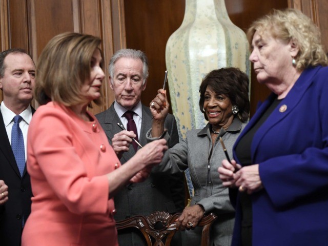 House Financial Services Committee Chairwoman Maxine Waters, D-Calif., holds up a pen presented to her by House Speaker Nancy Pelosi of Calif., after she signed the resolution to transmit the two articles of impeachment against President Donald Trump to the Senate for trial on Capitol Hill in Washington, Wednesday, Jan. …