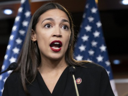 FILE - In this July 15, 2019 file photo Rep. Alexandria Ocasio-Cortez, D-N.Y., holds a new