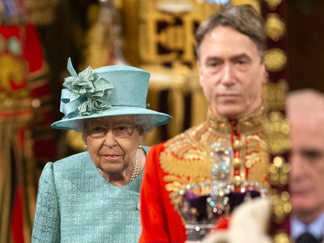 LONDON, ENGLAND - DECEMBER 19: Queen Elizabeth II walks through …