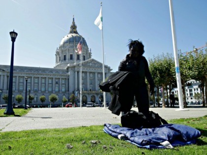 Homeless woman Allison Pope sets down her bag and belongings on a lawn across from City Hall in San Francisco, Wednesday, Aug. 21, 2019. (AP Photo/Jeff Chiu)