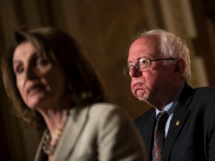 (L to R) House Minority Leader Nancy Pelosi (D-CA) speaks as Sen. Bernie Sanders (D-VT) lo