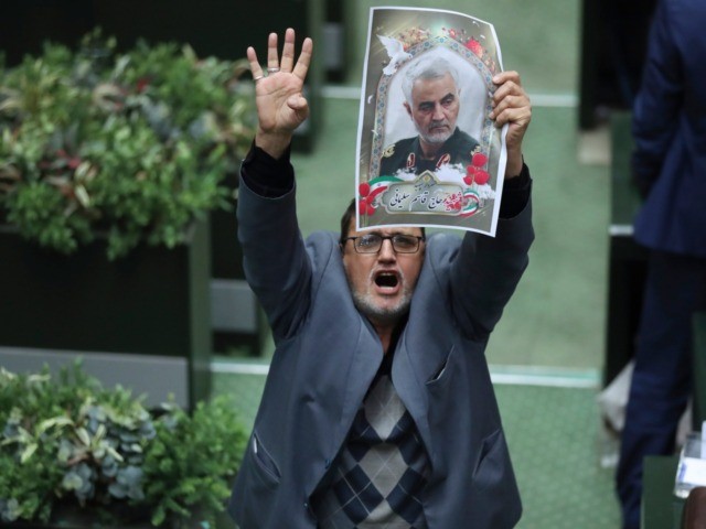 Iranian lawmaker Mohammad Javad Abtahi encourages his colleagues to vote for a bill as he